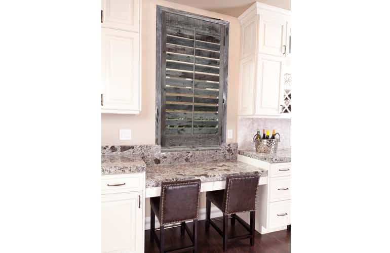 Kitchen window with reclaimed wood shutters in Houston